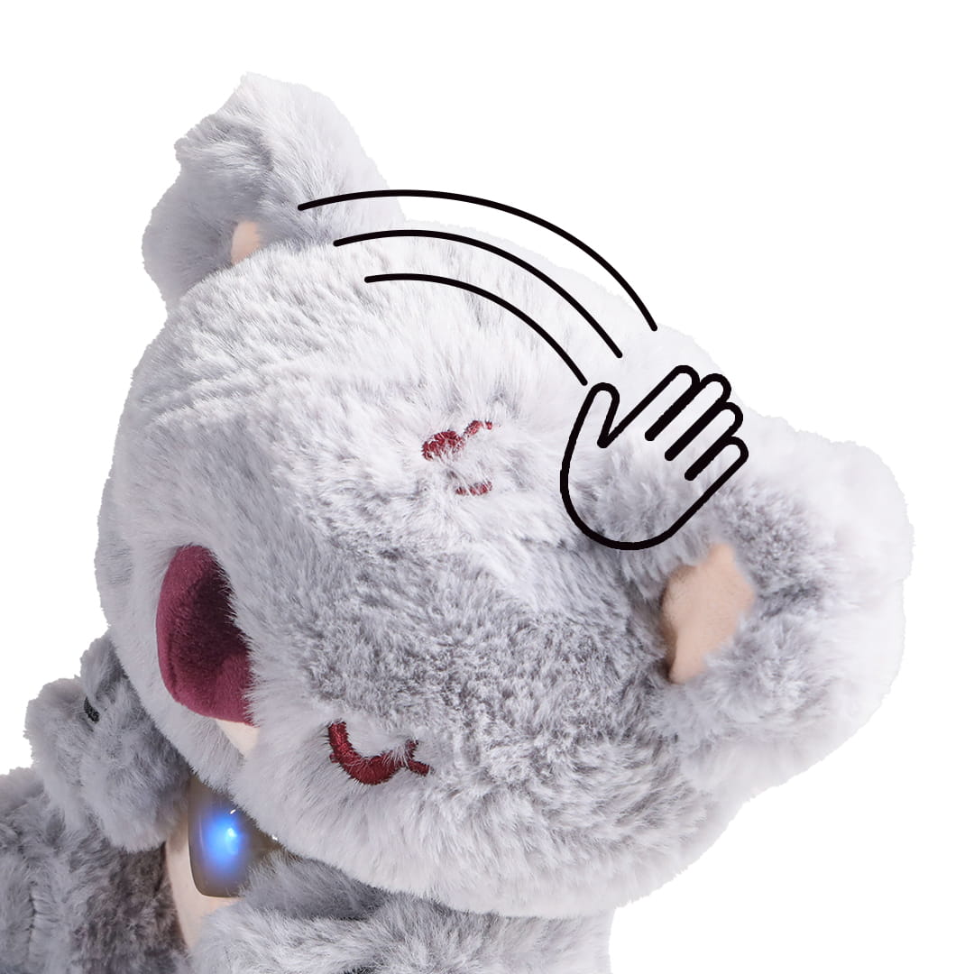 Mouvement de caresse sur la peluche interactive bébé koala avec cœur lumineux